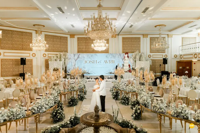 Grand Acacia Pavilion set with round tables and chandeliers.