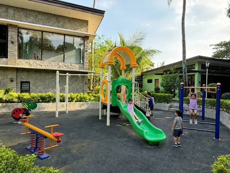Slides, swings, and open play space at the Batangas Country Club Kiddie Playground.